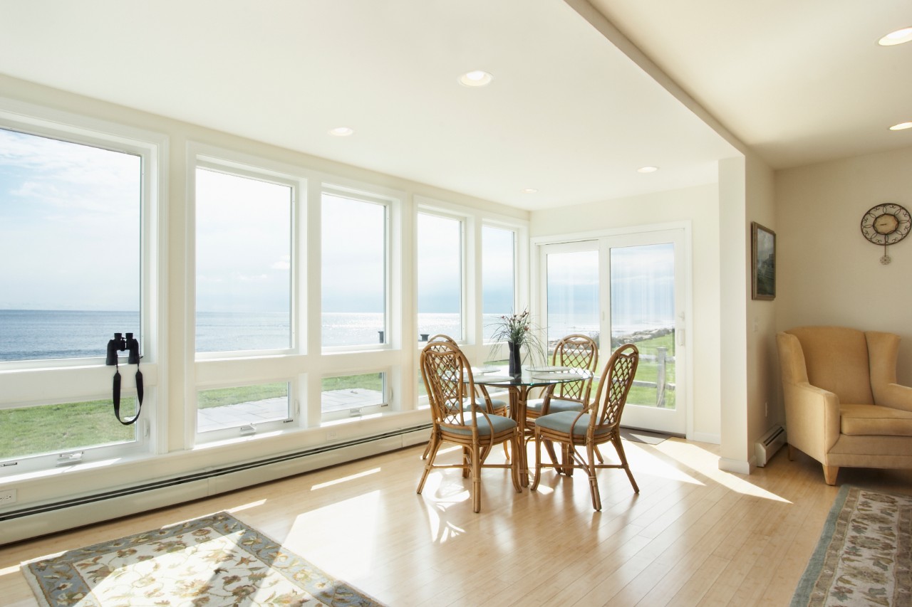 Flowers on white kitchen bench with splashback