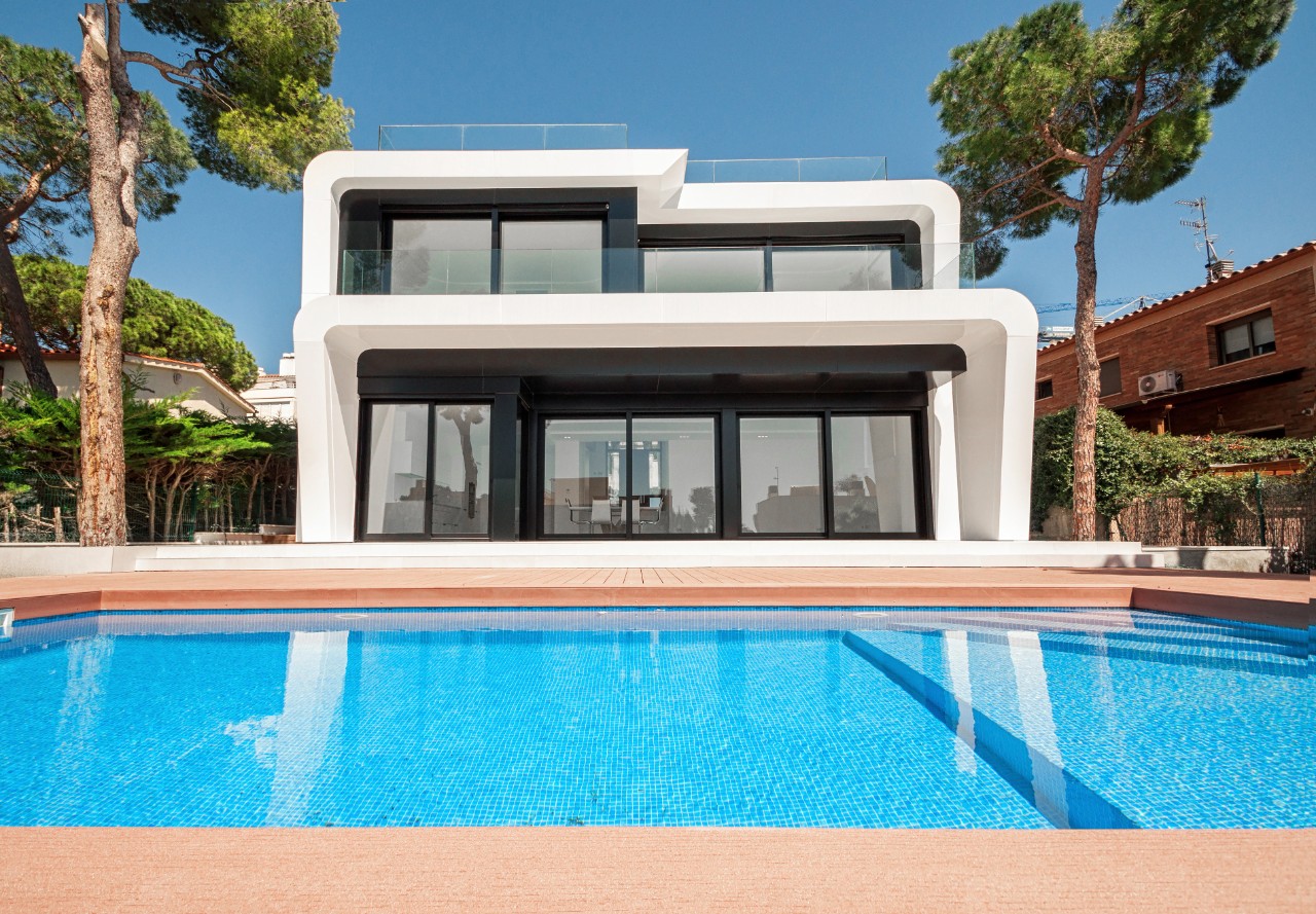 Luxurious villa with swimming pool at dusk. External view of a contemporary house. New technologies in construction.  