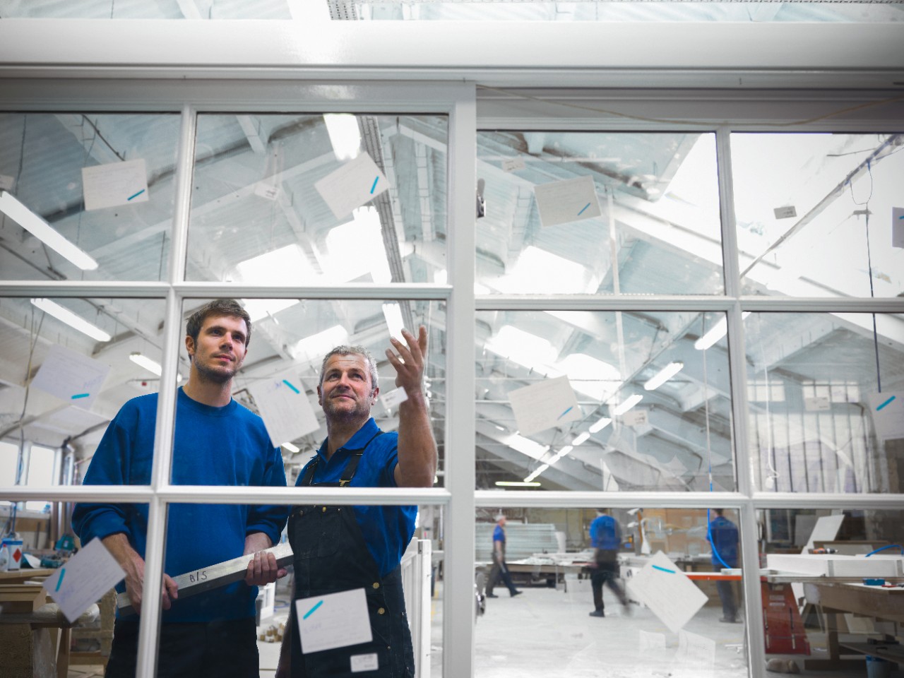 Workers examining window frames